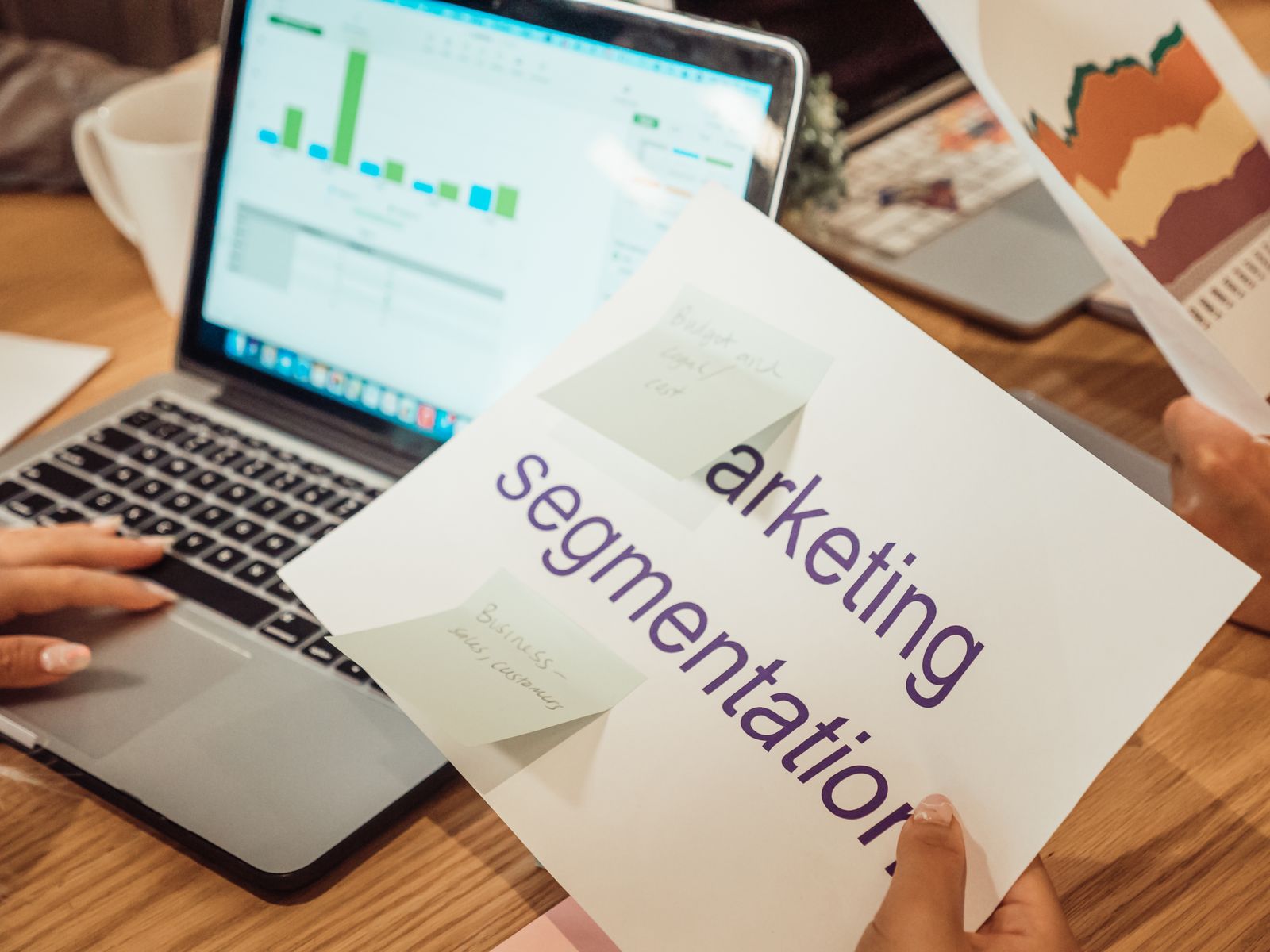 A printed marketing segmentation sheet resting on a laptop keyboard